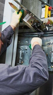 lift machinist adjusting elevator mechanism