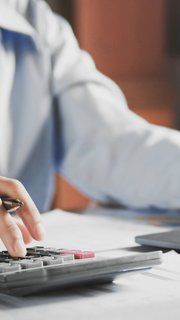 businesswoman working on desk using laptop for check data of finance in office