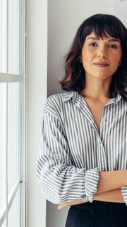 Confident female architect standing in office