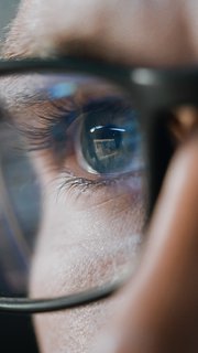 Close-up Portrait of Software Engineer Working on Computer, Line of Code Reflecting in Glasses. Developer Working on Innovative e-Commerce Application using Machine Learning, AI Algorithm, Big Data