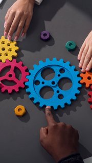 Business team connect pieces of gears. Teamwork, partnership and integration concept